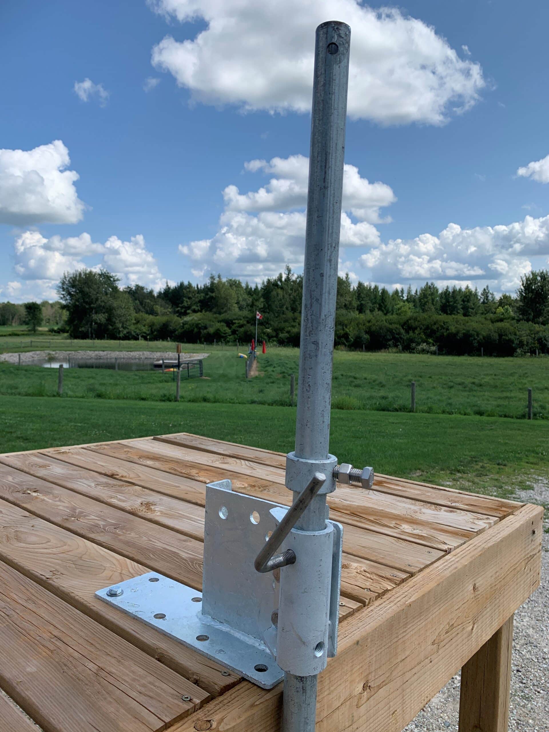 galvanized dock mount 5 (1) - Pond Perfections Galvanized dock mount 5-inch installed on a wooden dock in an outdoor area.