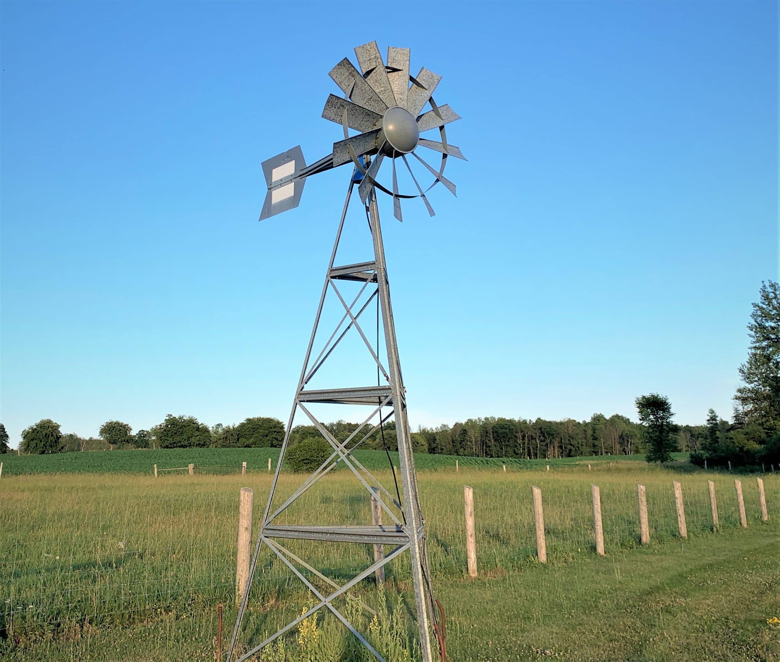 Windmill Glenannon - Pond Perfections Koenders Windmill standing in a rural field, designed for natural pond aeration.